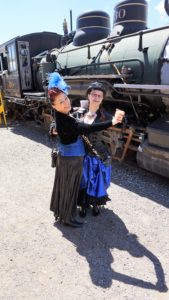 Steampunk girls dance by train
